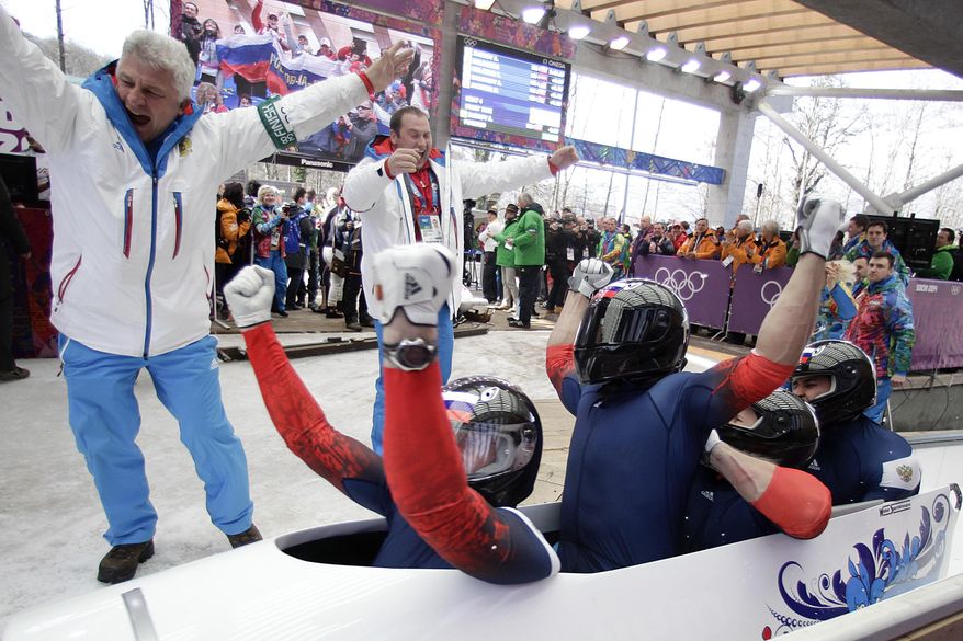 The team from Russia RUS-1, with Alexander Zubkov, Alexey Negodaylo, Dmitry Trunenkov, and Alexey Voevoda, celebrate after they won the gold medal during the men's four-man bobsled competition final at the 2014 Winter Olympics, Sunday, Feb. 23, 2014, in Krasnaya Polyana, Russia. (AP Photo/Jae C. Hong)