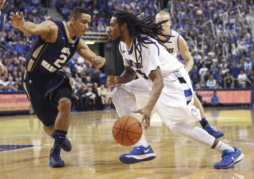 Saint Louis' Jordair Jett, right, heads to the basket as George Washington's Joe McDonald defends during the second half of an NCAA college basketball game Saturday, Feb. 22, 2014, in St. Louis. Saint Louis won 66-59. (AP Photo/Whitney Curtis)