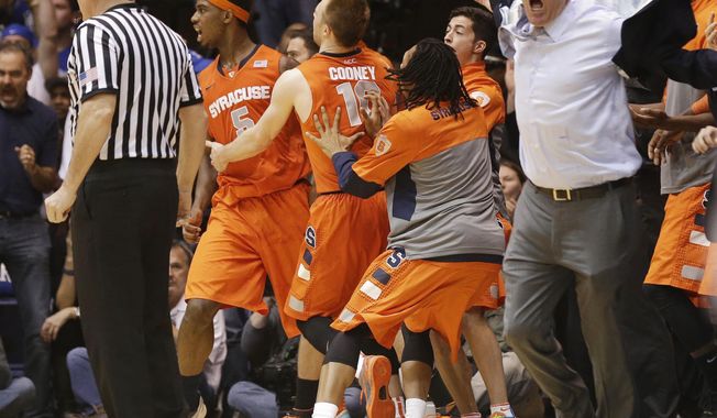 Syracuse coach Jim Boeheim, right, and players react to an official&#x27;s call late in the second half of an NCAA college basketball game against Duke in Durham, N.C., Saturday, Feb. 22, 2014. Duke won 66-60. (AP Photo/Gerry Broome)