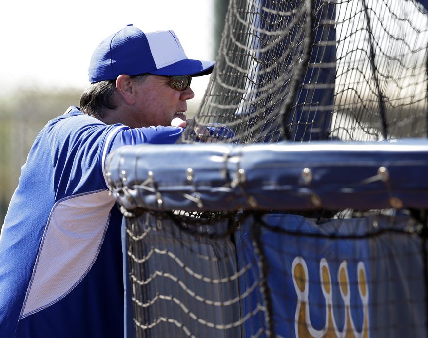 Kansa City Royals manager Ned Yost watches as players take batting practice during spring training baseball practice, Monday Feb. 24, 2014, in Surprise, Ariz. (AP Photo/Tony Gutierrez)