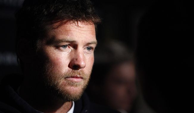 ** FILE ** In this Jan. 19, 2012, file photo, actor Sam Worthington attends the Cinema Society premiere of &quot;Man on a Ledge&quot; in New York. Police say Worthington has been arrested Sunday, Feb. 23, 2014, in New York City for punching a photographer after the man kicked Worthington&#x27;s girlfriend in the shin. The Australian actor was released on a desk appearance ticket and is due back in court on Feb. 26. (AP Photo/Peter Kramer, File)