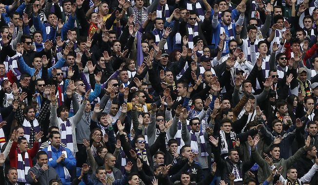 Real Madrid&#x27;s fans sing during a Spanish La Liga soccer match between Real Madrid and Elche at the Santiago Bernabeu stadium in Madrid, Spain, Saturday, Feb. 22, 2014. (AP Photo/Andres Kudacki)