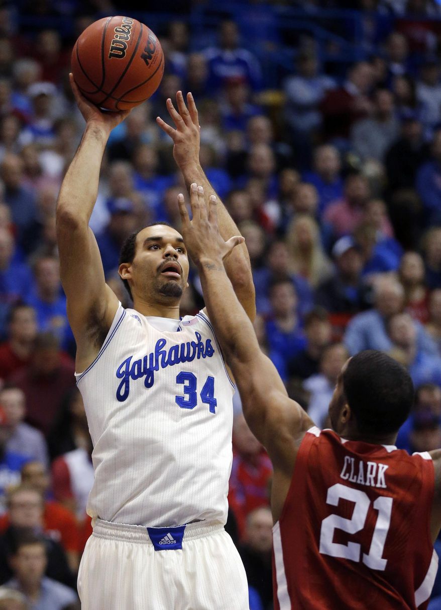 Kansas forward Perry Ellis (34) shoots over Oklahoma forward Cameron Clark (21) during the first half of an NCAA college basketball game in Lawrence, Kan., Monday, Feb. 24, 2014. (AP Photo/Orlin Wagner)