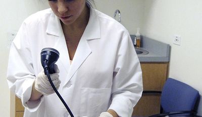 This 2010 photo from the National Heart, Lung and Blood Institute provided by the University of Illinois at Chicago shows a study participant undergoing a medical exam at the Chicago site of landmark research on the health of Hispanics in the United States. The ongoing National Heart, Lung and Blood Institute study involves more than 16,000 subjects in the Bronx, Chicago, Miami and San Diego. Results released Monday, Feb. 24, 2014, show health differences by country of origin.(AP Photo/Courtesy of the National Heart, Lung and Blood Institute via the University of Illinois at Chicago, Dr. Larissa Aviles-Santa)