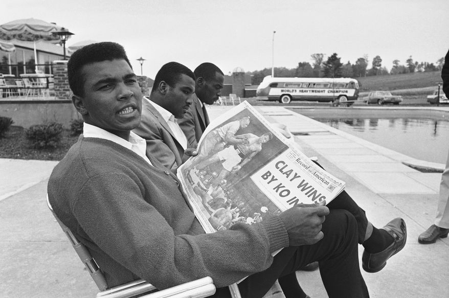 Banner headlines proclaiming his feat occupied the attention of heavyweight champion Muhammad Ali ?Cassius Clay? at his motel at nearby Auburn. Clay successfully retained crown via a one-round KO over Sonny Liston in Lewiston, Me., on May 26, 1965. (AP Photo)