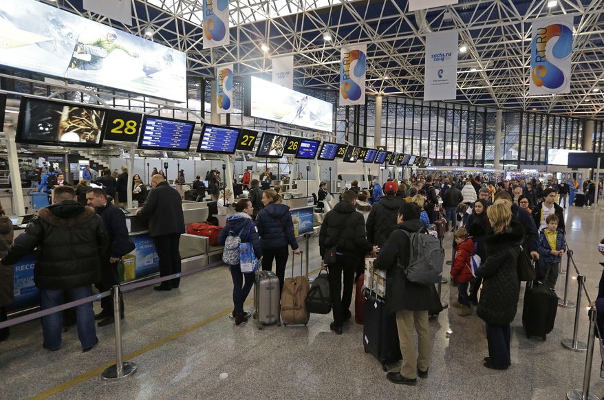 Guest check-in for their flights at the Sochi Airport following the 2014 Winter Olympics, Monday, Feb. 24, 2014, in Sochi, Russia. (AP Photo/Darron Cummings)