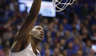 Kansas center Joel Embiid dunks during the first half of an NCAA college basketball game against Oklahoma in Lawrence, Kan., Monday, Feb. 24, 2014. (AP Photo/Orlin Wagner)