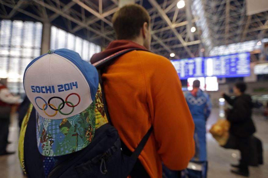 A passenger checks the status of flights at the Sochi Airport following the 2014 Winter Olympics, Monday, Feb. 24, 2014, in Sochi, Russia. (AP Photo/Darron Cummings)