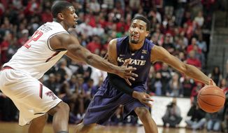 Kansas State&#39;s  Shane Southwell (1) looks to pass around Texas Tech&#39;s Jordan Tolbert during an NCAA college basketball game in Lubbock, Texas, Tuesday, Feb, 25, 2014. (AP Photo/Lubbock Avalanche-Journal, Stephen Spillman) ALL LOCAL TV OUT