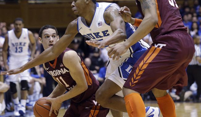 Virginia Tech&#x27;s Devin Wilson (11) looks to pass to Jarell Eddie (31) as Duke&#x27;s Rodney Hood defends during the first half of an NCAA college basketball game in Durham, N.C., Tuesday, Feb. 25, 2014. (AP Photo/Gerry Broome)