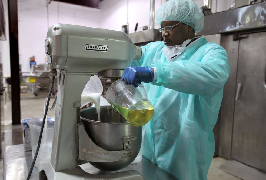 Larry Davis, 55, of Redford, Michl, makes small batches of baguettes at Awrey's Bakery in Livonia, Mich., on Feb. 17, 2014. It was a year ago that Awrey's Bakery, one of the few remaining iconic Detroit-area brands, avoided permanent closure in a down-to-the-wire purchase deal. The new buyers, Michigan residents Ron Beebe and James McColgan, bought the Livonia bakery from a pair of out-of-state private equity firms just hours before its equipment was to be sold at liquidation auction. The 200-some Awrey's employees were already out the door. In their place were auctioneers. (AP Photo/Detroit Free Press, Jessica J. Trevino) DETROIT NEWS OUT; NO SALES