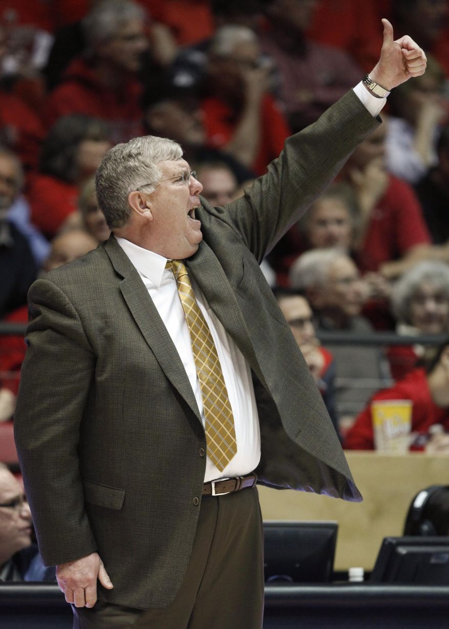 Utah State coach Steve Morrill signals to his players during the first half of an NCAA college basketball game against New Mexico, Tuesday, Feb. 25, 2014 in Albuquerque, N.M. (AP Photo/Craig Fritz)