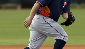 Houston Astros&#39; Jose Altuve keeps his eye on the ball as he moves in position during a spring training baseball workout, Friday, Feb. 21, 2014, in Kissimmee, Fla. (AP Photo/Alex Brandon)