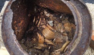This image provided by the Saddle Ridge Hoard discoverers via Kagin&#39;s, Inc., shows one of the six decaying metal canisters filled with 1800s-era U.S. gold coins unearthed in California by two people who want to remain anonymous. The value of the &amp;quot;Saddle Ridge Hoard&amp;quot; treasure trove is estimated at $10 million or more. (AP Photo/Saddle Ridge Hoard discoverers via Kagin&#39;s, Inc.)