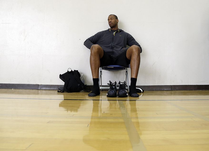 Brooklyn Nets center Jason Collins prepares for an off-day practice on the campus of UCLA in Los Angeles Tuesday, Feb. 25, 2014. Collins became the first openly gay athlete in North America's four major professional sports Sunday, Feb. 23, signing a 10-day contract with the Brooklyn Nets. (AP Photo/Reed Saxon)