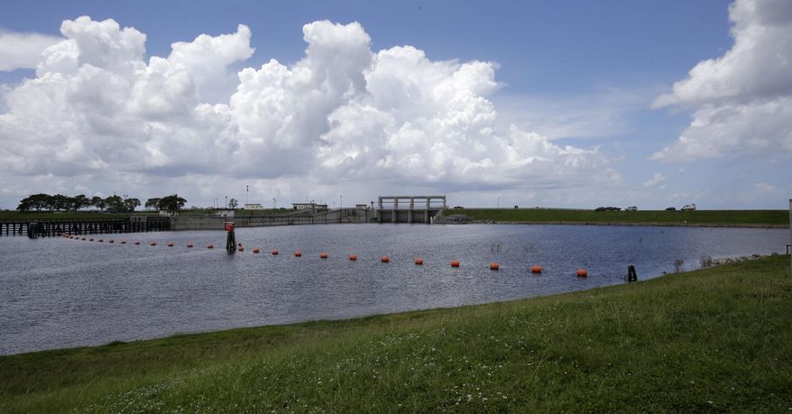 In this Friday, Aug. 9, 2013 photo, Port Mayaca Lock & Dam in Lake Okeechobee, Fla., is seen. A Tallahassee lawmaker called on Florida’s congressional delegation to help the state take charge of controlling how water is released from Lake Okeechobee. The lake and water woes from Florida’s Big Bend to the state’s natural springs to a treasured estuary along the Atlantic have prompted residents, lawmakers and environmental advocates to call on the state to do more to better manage its water resources. (AP Photo/Alan Diaz)