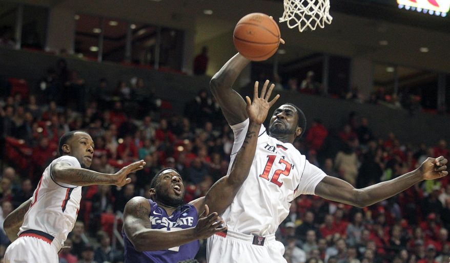 Kansas State's Omari Lawrence (12) is defended by Texas Tech's Jamal Williams, Jr.(23) and Kader Tapsoba (12) during an NCAA college basketball game in Lubbock, Texas, Tuesday, Feb, 25, 2014. (AP Photo/Lubbock Avalanche-Journal, Stephen Spillman) ALL LOCAL TV OUT