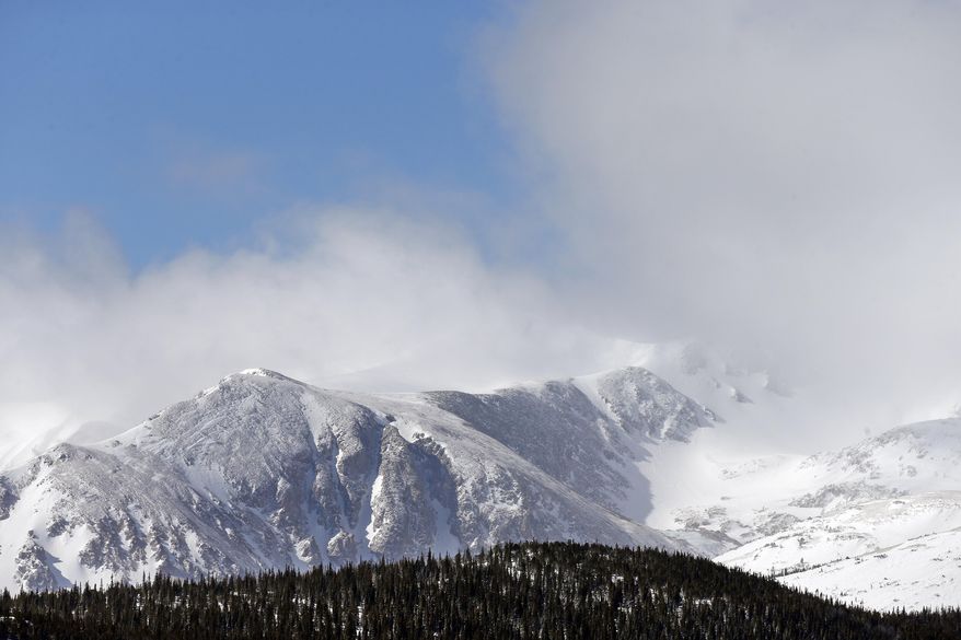 The wind scours and redeposits snow in the Indian Peaks Wilderness, as seen from Eldora Mountain Resort, near Nederland, Colo., Wednesday, Feb. 26, 2014. Lots of new snow and strong winds in the past month have fueled dangerous conditions from the Cascades to the Rockies, prompting forecasters to issue warnings of considerable or high avalanche dangers for many areas outside of established ski areas. (AP Photo/Brennan Linsley)