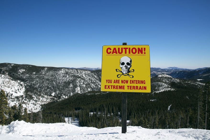 A sign alerts skiers to danger on Corona Bowl, known for its extreme skiing, at Eldora Mountain Resort, near Nederland, Colo., Wednesday, Feb. 26, 2014. Lots of new snow and strong winds in the past month have fueled dangerous conditions from the Cascades to the Rockies, prompting forecasters to issue warnings of considerable or high avalanche dangers for many areas outside of established ski areas. (AP Photo/Brennan Linsley)