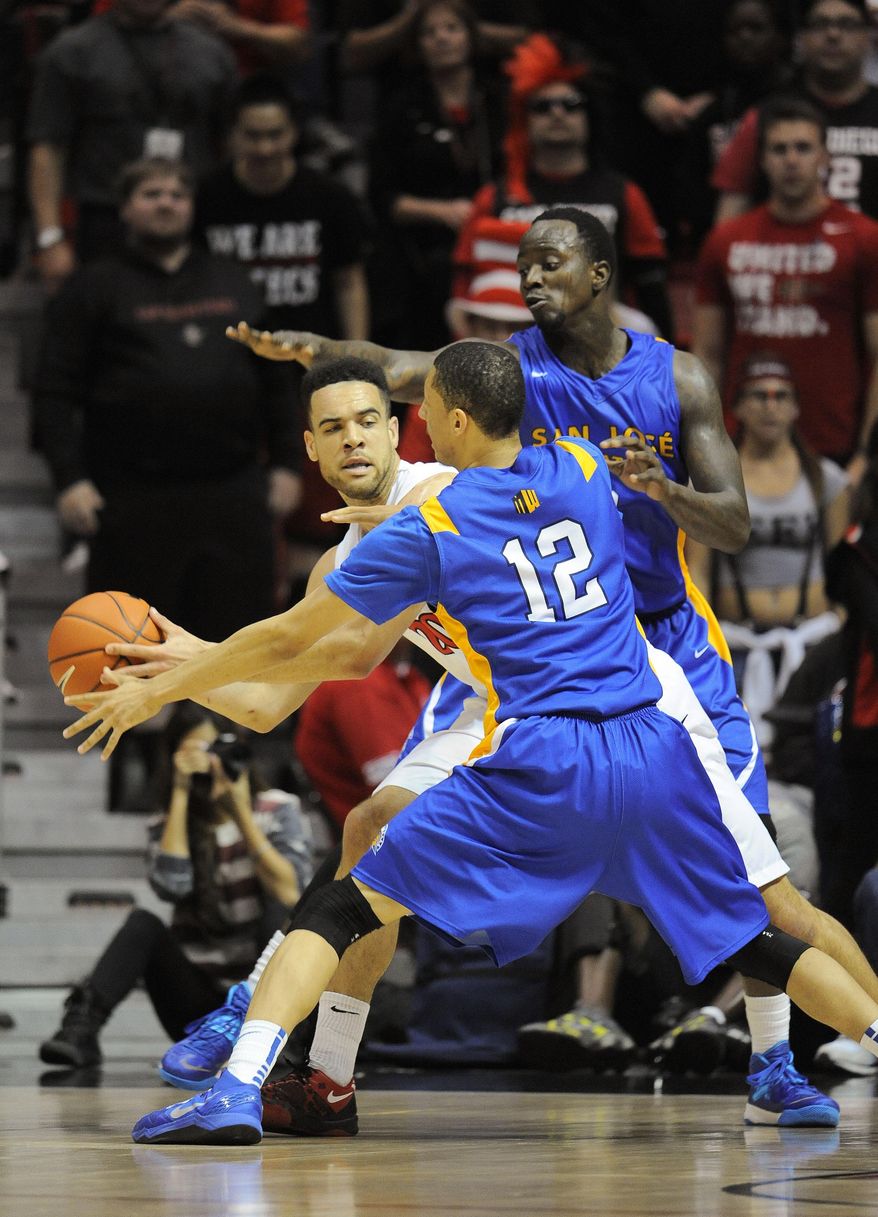San Jose State's Rashad Muhammad (0) and Jalen James (12) double team San Diego State's JJ O'Brien (20) during the first half of an NCAA college basketball game on Tuesday, Feb. 25, 2014, in San Diego. (AP Photo/Denis Poroy)