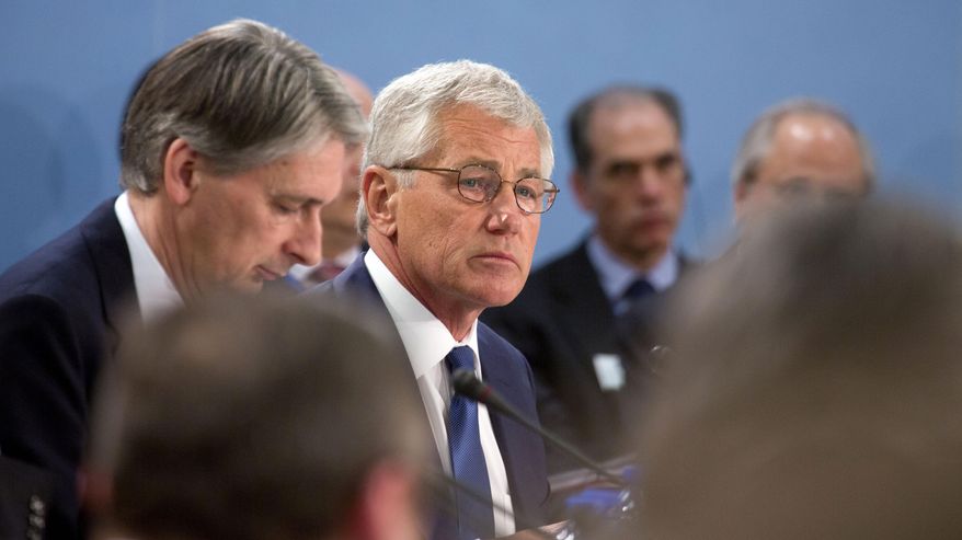 U.S. Secretary of Defense Chuck Hagel, center, attends a meeting of defense ministers of the North Atlantic Council at NATO headquarters in Brussels on Wednesday, Feb. 26, 2014. Frustrated with his Afghan counterpart, U.S. President Barack Obama is ordering the Pentagon to accelerate planning for a full U.S. troop withdrawal from Afghanistan by the end of this year. But Obama is also holding out hope that Afghanistan's next president may eventually sign a stalled security agreement that could prevent the U.S. from having to take that step. (AP Photo/Virginia Mayo)