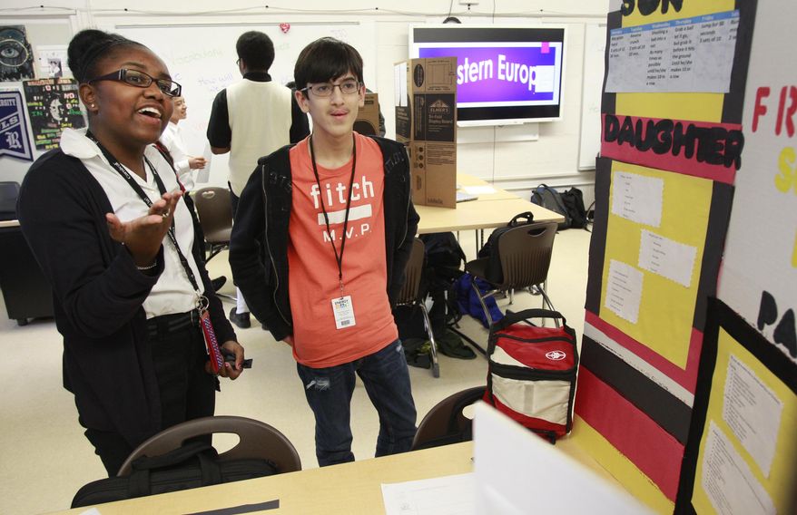 FOR RELEASE SUNDAY, MARCH 2, 2014, AT 12:01 A.M. CST. - In this photo from Feb. 20, 2014, Kaleigh Davis, left, and Johnpaul Kliebert, both 14, work on a project about Frankfurt at the Energy Institute High School in Houston. It is the first high school in the nation to focus on careers in oil, gas and other energy sources and technologies. (AP Photo/Houston Chronicle, Melissa Phillip)
