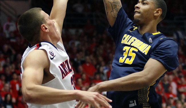 California&#x27;s Richard Solomon (35) shoots for two points over the attempted defense of Arizona&#x27;s Kaleb Tarczewski, left, in the first half of an NCAA college basketball game on Wednesday, Feb. 26, 2014, in Tucson, Ariz. (AP Photo/John MIller)