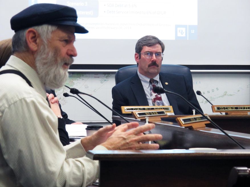 House Resources Committee co-chair Eric Feige, R-Chickaloon, right, listens as Rep. Paul Seaton, R-Homer, speaks during a hearing on the potential fiscal impacts of a major liquefied natural gas project on Wednesday, Feb. 26, 2014, in Juneau, Alaska. (AP Photo/Becky Bohrer)