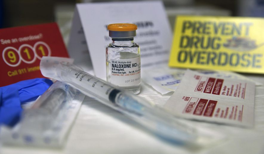 A kit with naloxone, also known by its brand name Narcan, is displayed at the South Jersey AIDS Alliance in Atlantic City, N.J., on Feb. 19, 2014. An overdose of opiates essentially makes the body forget to breathe. Naloxone works by blocking the brain receptors that opiates latch onto and helping the body "remember" to take in air. (Associated Press) **FILE**