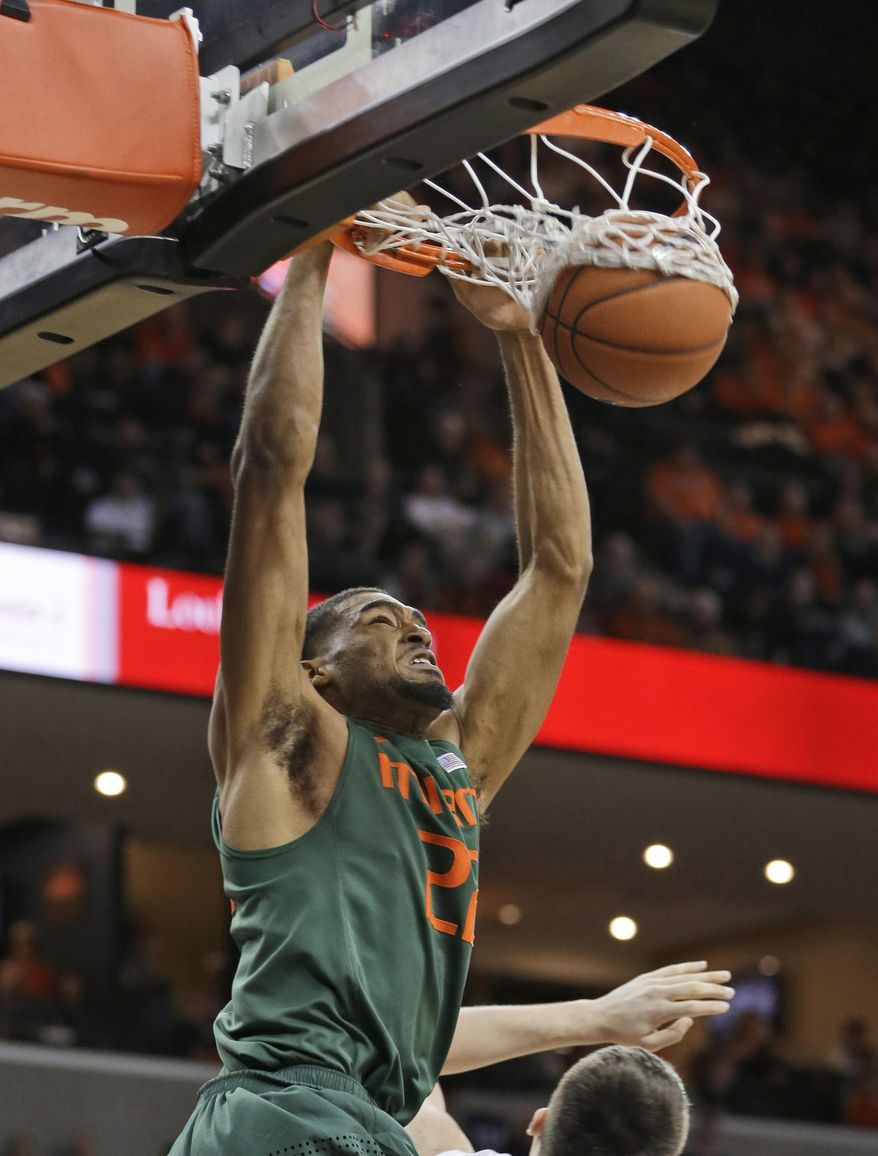 Miami forward Donnavan Kirk (22) dunks during the first half of an NCAA college basketball game against Virginia in Charlottesville, Va., Wednesday, Feb. 26, 2014. (AP Photo/Steve Helber)