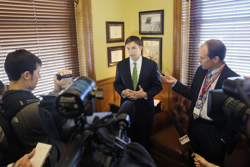 Arkansas House Speaker Davy Carter, R-Cabot, center, speaks to reporters gathered in the Speaker's office at the Arkansas state Capitol in Little Rock, Ark., Wednesday, Feb. 26, 2014. The House did not vote on the "private option" Medicaid expansion plan Wednesday. (AP Photo/Danny Johnston)