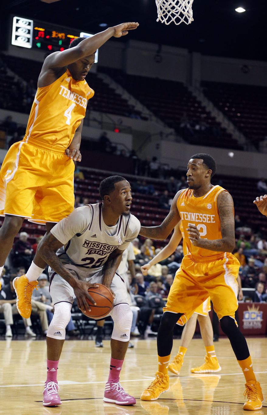 Mississippi State forward Roquez Johnson (25) looks for help as he is blocked by Tennessee guards Armani Moore (4) and Jordan McRae (52) in the first half of an NCAA college basketball game in Starkville, Miss., Wednesday, Feb. 26, 2014. (AP Photo/Rogelio V. Solis)