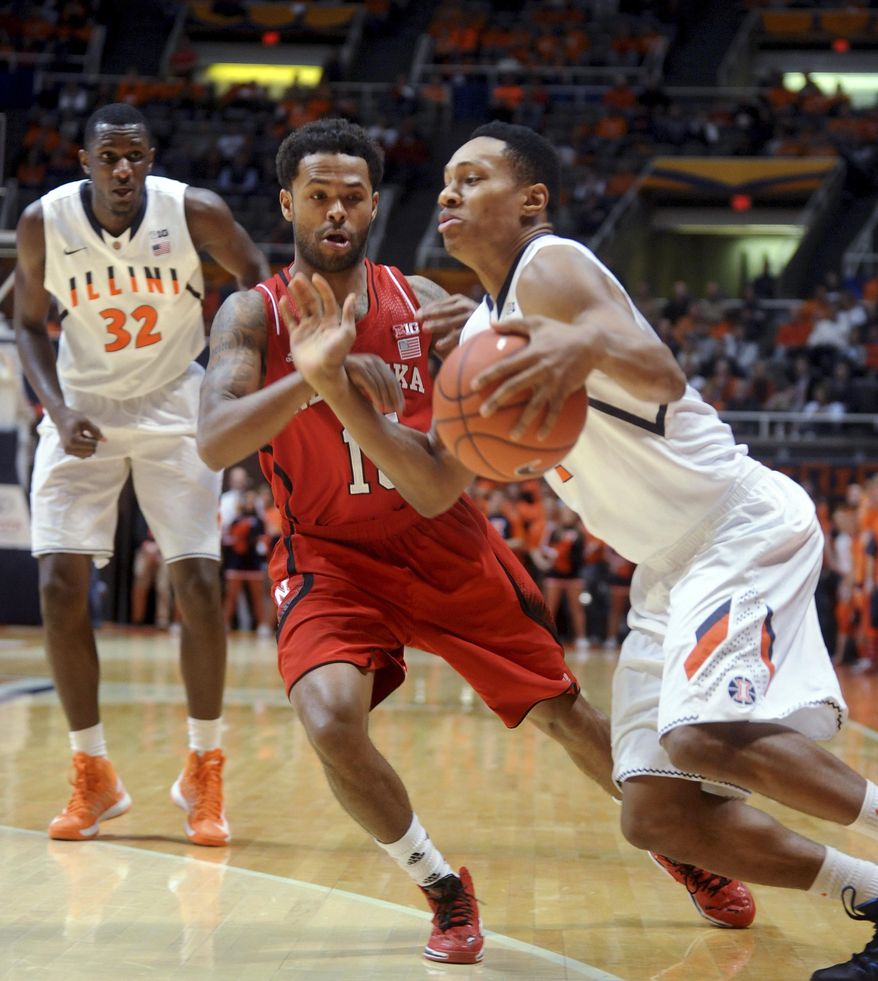 Illinois' Joseph Bertrand (2) tries to drive the ball around Nebraska's Ray Gallegos (15) as Illinois' Nnanna Egwu (32) watches during the first half of an NCAA college basketball game Wednesday, Feb. 26, 2014, in Champaign, Ill. (AP Photo/Heather Coit)
