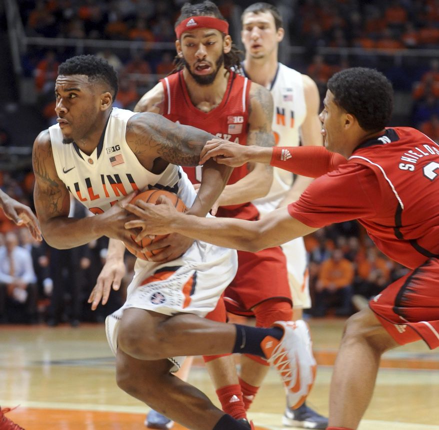 Illinois' Ravonte Rice tries to keep a grip on the ball as Nebraska's Shavon Shields (31) makes a grab while Nebraska's Terran Petteway and Illinois' Maverick Morgan (22) watch during the first half of an NCAA college basketball game in Champaign, Ill., on Wednesday, Feb. 26, 2014. (AP Photo/Heather Coit)