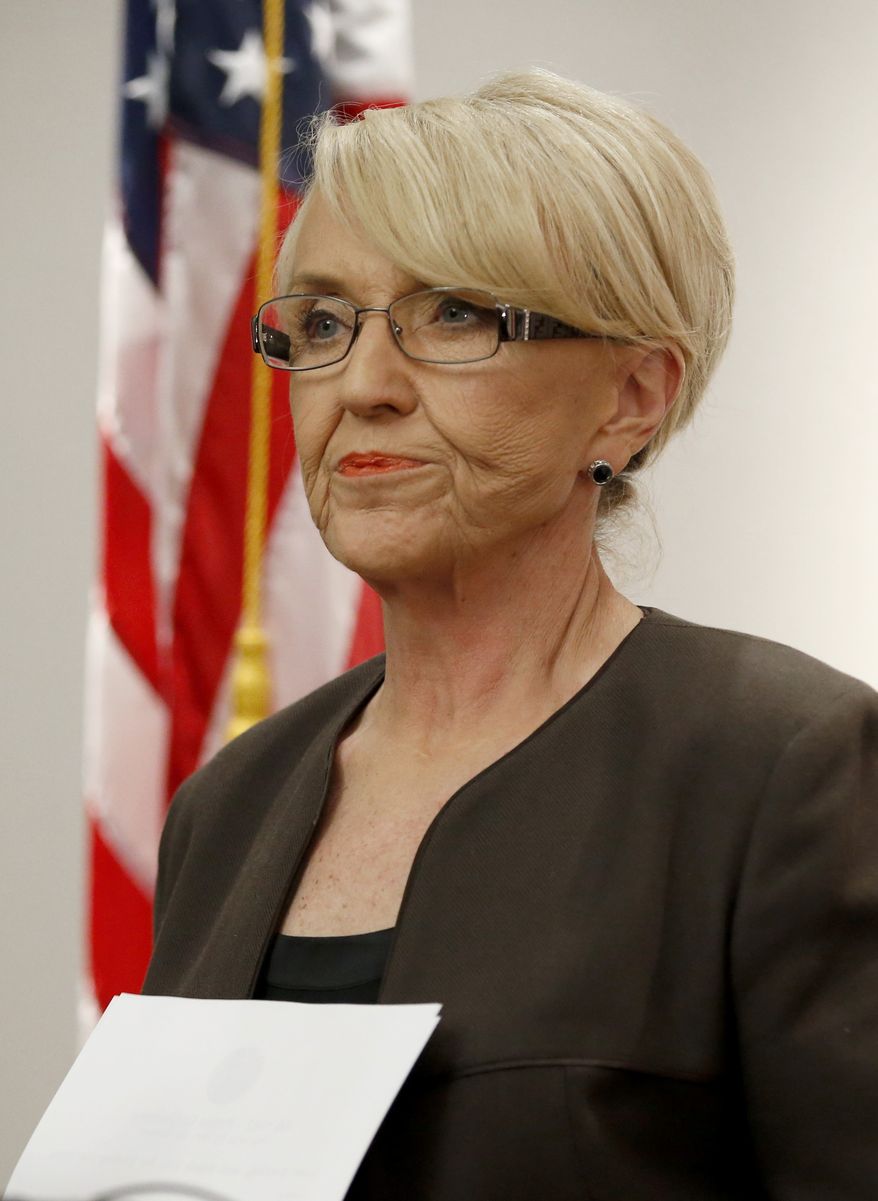 Arizona Republican Gov. Jan Brewer finishes speaking at a news conference announcing she has vetoed SB1062, a bill designed to give added protection from lawsuits to people who assert their religious beliefs in refusing service to gays, at the Arizona Capitol on Wednesday, Feb. 26, 2014, in Phoenix. (AP Photo/Ross D. Franklin)