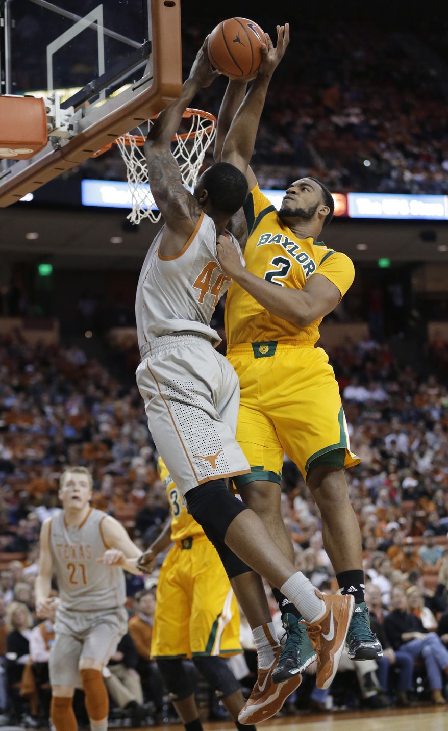 Texas' Prince Ibeh (44) is blocked by Baylor's Rico Gathers (2) during the first half of an NCAA college basketball game, Wednesday, Feb. 26, 2014, in Austin, Texas. (AP Photo/Eric Gay)
