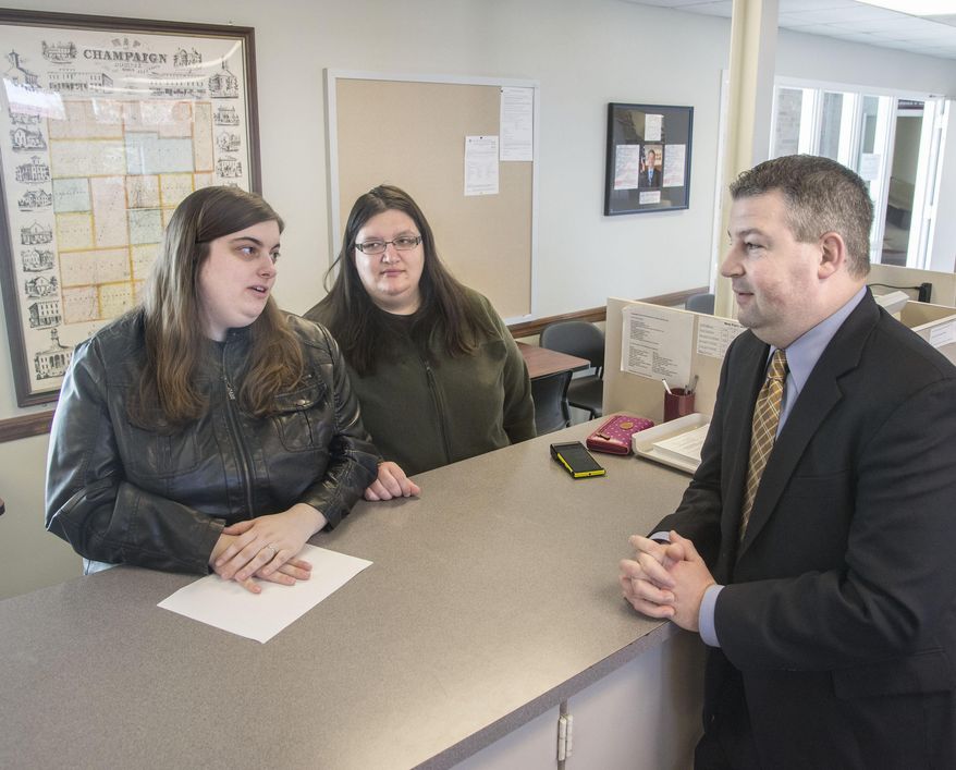 Marissa Meli, left, and Laura Meli talk to Champaign County Clerk Gordy Hulten while they wait for the marriage license to be printed at Champaign County Champaign County Clerks office in Urbana, Ill., on Wednesday Feb. 26, 2014. Champaign County officials said the central Illinois county would begin issuing same-sex marriage licenses Wednesday, making it the second county to do so after a federal judge ruled Cook County gay couples wouldn’t have to wait until Illinois’ new gay marriage law takes effect this summer. (AP Photo/News-Gazette, John Dixon) MANDATORY CREDIT