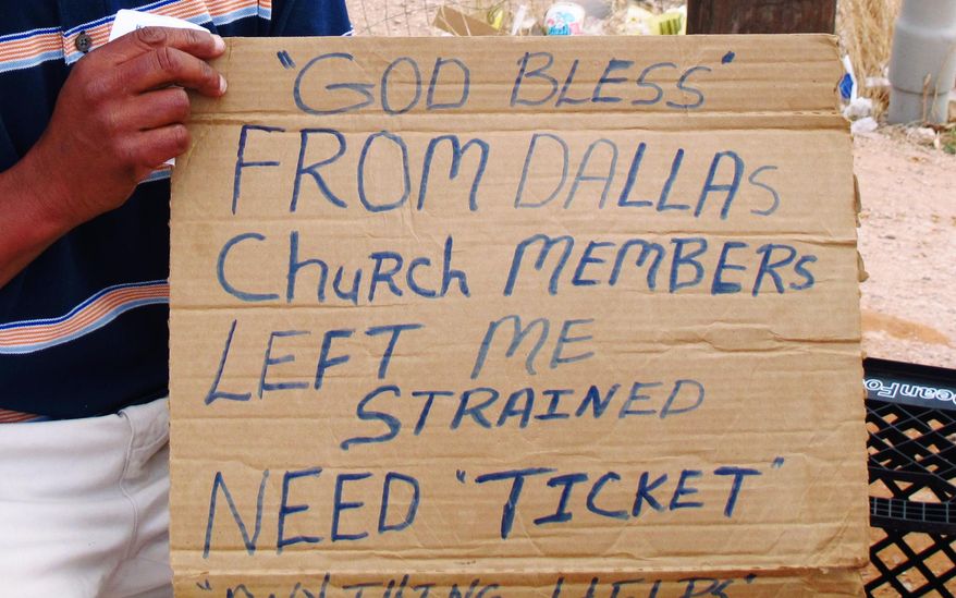 In this photo from Feb. 24, 2014, Joseph Johnson, a homeless man, holds the sign he uses when he asks motorists in Midland, Texas, for donations. Two Midland police officers were disciplined with a three-day suspension recently for having a contest to see who could confiscate the most signs from homeless people. (AP Photo/Betsy Blaney)