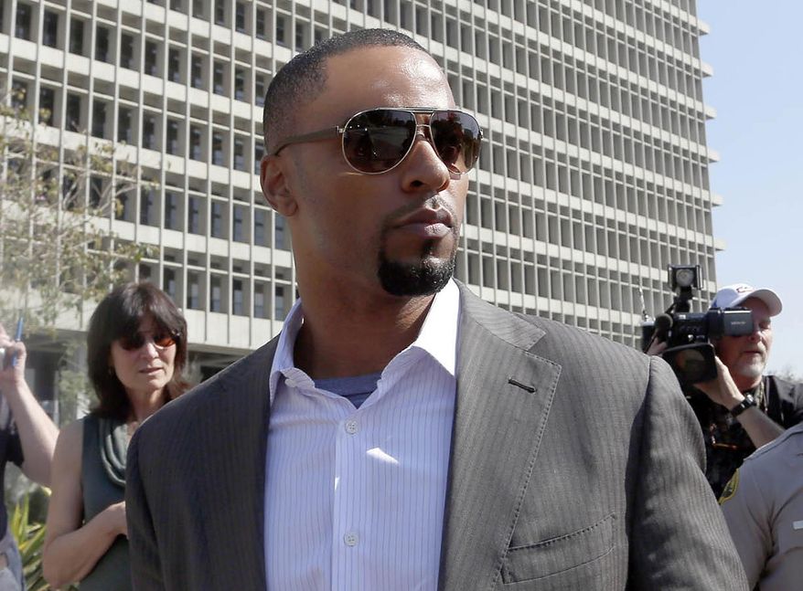 In this Feb. 14, 2014, photo, former NFL safety Darren Sharper leaves a courthouse in Los Angeles. An arrest warrant has been issued for Sharper and another man, accusing them of raping two women in New Orleans last year. Sharper also is under investigation in sexual assault cases in Florida, Nevada and Arizona and has pleaded not guilty to rape charges in Los Angeles. (AP Photo/Nick Ut )