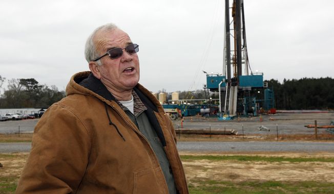 In this Dec. 23, 2013 photograph, Amite County Supervisor Max Lawson describes the convoy of about 200 trucks carting in a drilling rig and other gear on what was pasture land at his Gillsburg, Miss., farm. After a little more than a two-year wait, Encana Corp., contractors were finally drilling. Oil companies plan a big increase in drilling activity in 2014 in southwest Mississippi. They're trying to extract oil from a formation called the Tuscaloosa Marine Shale, which one study says could hold 7 billion barrels. (AP Photo/Rogelio V. Solis)