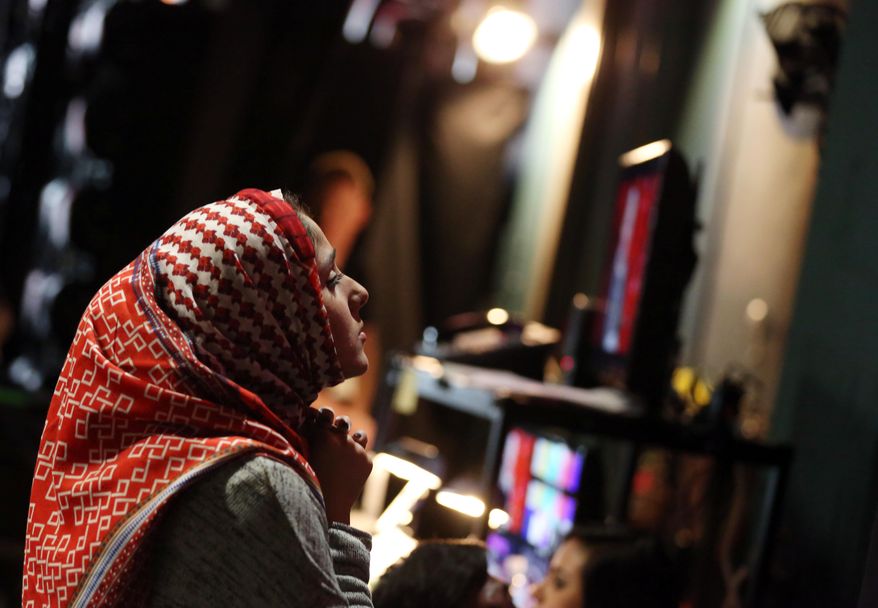 Zaineb Abdul-Nabi, 22, is seen backstage during rehearsals for the 86th Academy Awards in Los Angeles, Wednesday, Feb. 26, 2014. Abdul-Nabi was among the six aspiring young filmmakers selected from colleges across the country that will be handing Oscar statuettes to the stars presenting them on Sunday, March 2, 2014. (Photo by Matt Sayles/Invision/AP)