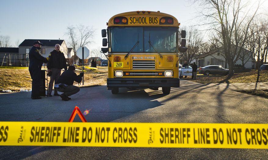 Investigators work the scene of an accident in Taylorsville, Ind. after two children were struck by a school bus Thursday, Feb. 27, 2014. Bartholomew County sheriff's Chief Deputy Todd Noblitt says a 9-year-old girl had serious injuries and was flown to Riley Hospital for Children in Indianapolis. Noblitt tells The Republic that a 6-year-old boy was taken to Columbus Regional Hospital. (AP Photo/The Republic, Andrew Laker)