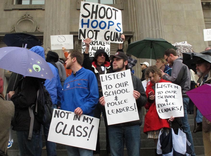 Protestors rally on the steps of the Idaho Statehouse in Boise, Idaho to protest SB1254, a bill seeking to allow concealed weapons on the state's college campuses, Thursday, Feb. 27, 2014.(AP Photo/John Miller)