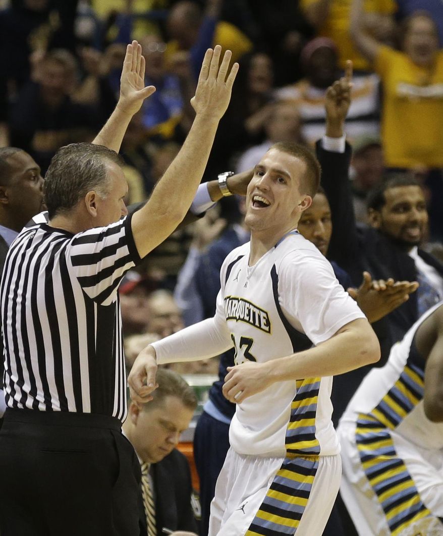 Marquette's Jake Thomas reacts after his 3-point basket against Georgetown during the second half of an NCAA college basketball game on Thursday, Feb. 27, 2014, in Milwaukee. (AP Photo/Jeffrey Phelps)