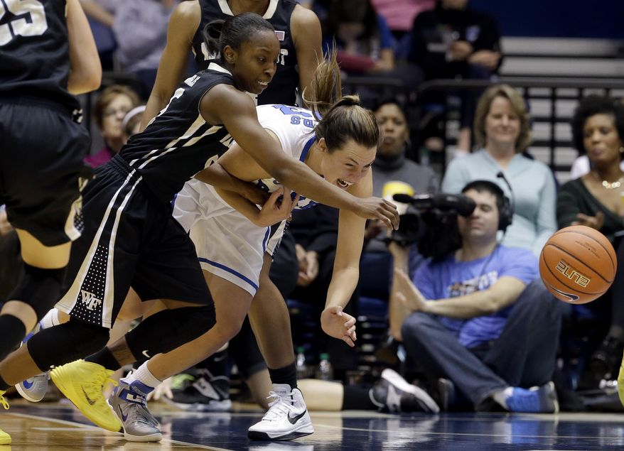 Wake Forest's Chelsea Douglas, left, and Duke's Haley Peters chase a loose ball during the second half of an NCAA college basketball game in Durham, N.C., Thursday, Feb. 27, 2014. Duke won 71-56. (AP Photo/Gerry Broome)