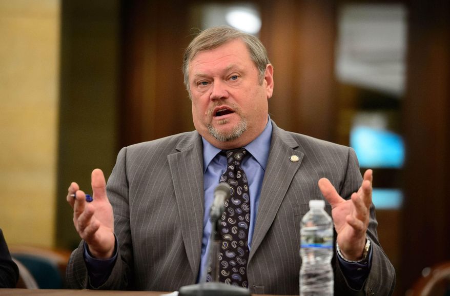 FILE - In this Feb. 19, 2014 file photo, Senate Majority Leader Thomas Bakk talks with other Minnesota legislative leaders about the agenda for the upcoming legislative session in St. Paul, Minn. While talks go on about about possible tax cuts with the state's budget surplus, Bakk, D-Cook, said he'll insist on building a bigger reserve as final negotiations arrive this year. (AP Photo/The Star Tribune, Glen Stubbe,File)