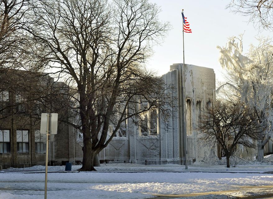 An early morning fire on Thursday, Feb. 27, 2014 severely damaged Mitchell Elementary School in Racine, Wis. The fire severely damaged the school, causing the gymnasium roof to collapse. School administrators have canceled classes at the damaged school. (AP Photo/The Journal Times, Scott Anderson)