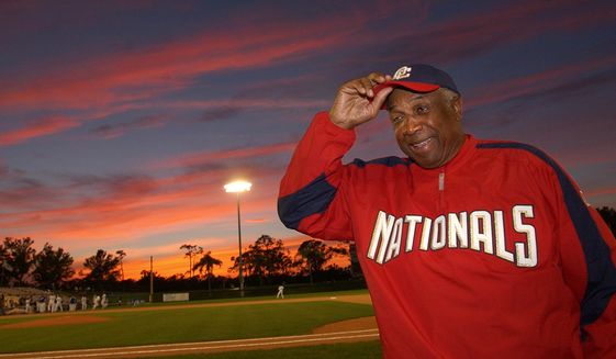 Washington Nationals manager Frank Robinson adjusts his hat before the game against the Los Angeles Dodgers in Vero Beach, Fla., Monday, March 28, 2005. (AP Photo/LM Otero) ** FILE **