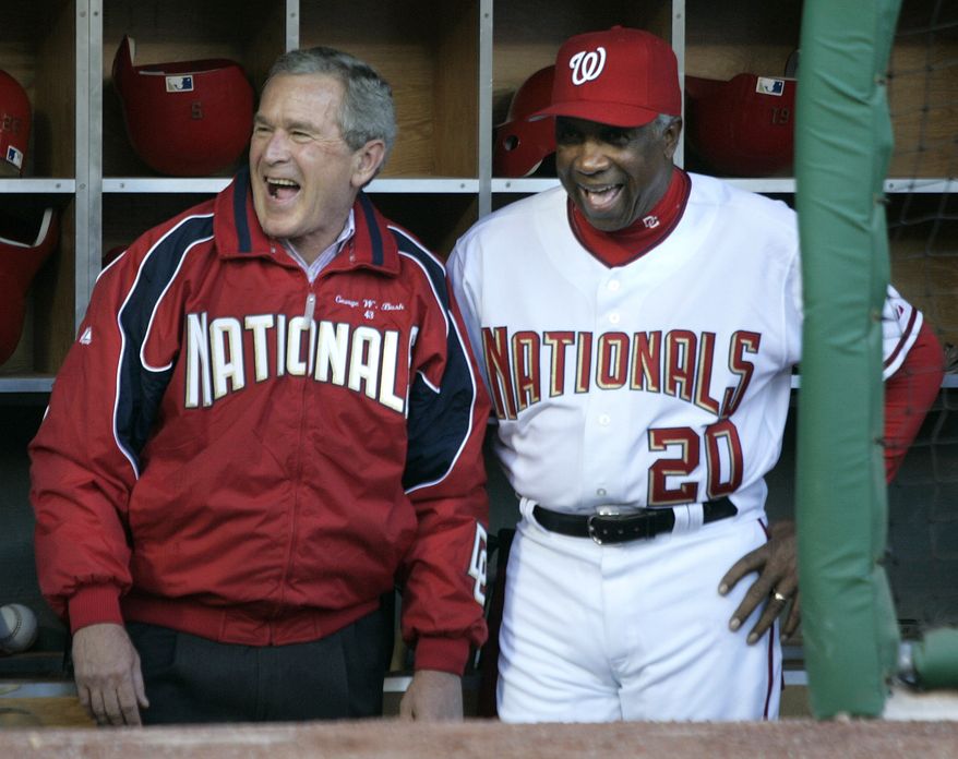 President Bush shares a laugh with Washington Nationals manager, Frank Robinson, before throwing out the first pitch at RFK Stadium in game between the Nationals and Arizona Diamondbacks, Thursday, April 14, 2005, in Washington. It's the Nationals first regular-season baseball game in the nation's capital in 34 years. (AP Photo/Lawrence Jackson)