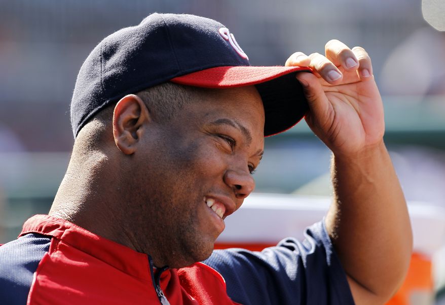 **FILE** Washington Nationals pitcher Livan Hernandez smiles at a teammate during the fifth inning of a baseball game against the Houston Astros in Washington, Sunday, Sept. 11, 2011. The Nationals beat the Astros 8-2. (AP Photo/Ann Heisenfelt)